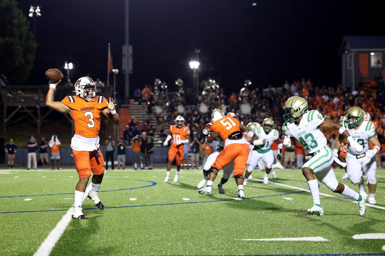 August 20, 2021 - Kennesaw, Ga: North Cobb quarterback Malachi Singleton (3) throws under pressure from Buford linebacker Malik Spencer (43) for a touchdown during the first half at North Cobb high school Friday, August 20, 2021 in Kennesaw, Ga.. JASON GETZ FOR THE ATLANTA JOURNAL-CONSTITUTION