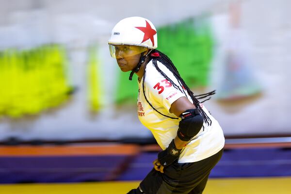 Natasha Cook, aka Trouble MakeHer, scrimmages at the Atlanta Roller Derby practice facility in Mableton on Wednesday, May 22, 2024. (Arvin Temkar / AJC)