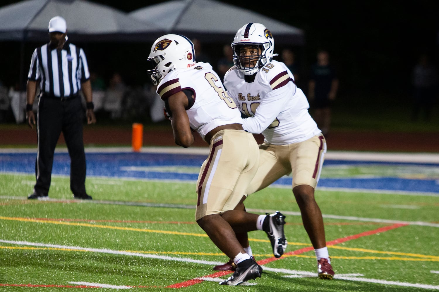 Qamar Grant, quarterback for Pebblebrook, hands the ball off to  Dylan Montoya, running back for Pebblebrook, during the Harrison vs. Pebblebrook high school football game on Friday, September 23, 2022, at Harrison high school in Kennesaw, Georgia. Pebblebrook defeated Harrison 31-14. CHRISTINA MATACOTTA FOR THE ATLANTA JOURNAL-CONSTITUTION.