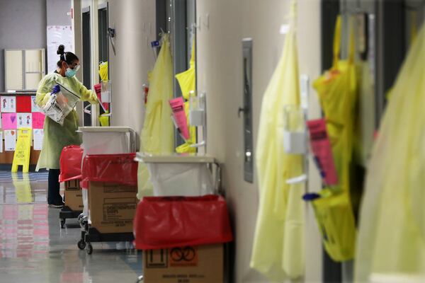 Ceri West, a registered nurse, enters one of the eight monoclonal antibody infusion rooms at Phoebe Putney Memorial Hospital in Albany  on Monday. Curtis Compton / Curtis.Compton@ajc.com”