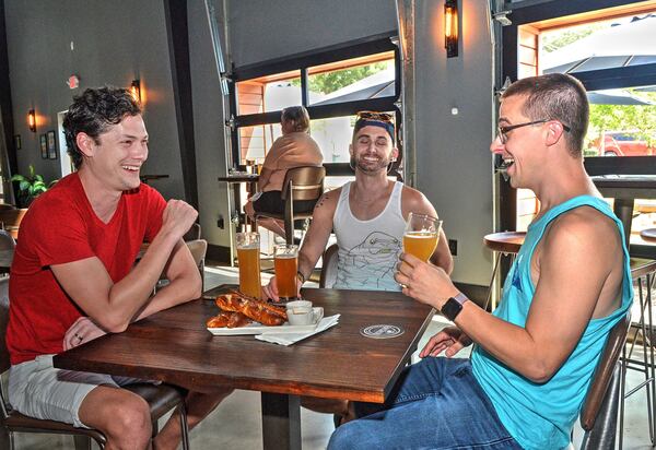 Alex Rhinehart, Eric Laska and Nick Jones enjoy beer and fresh-made Tavern Pretzels at the Lost Druid.