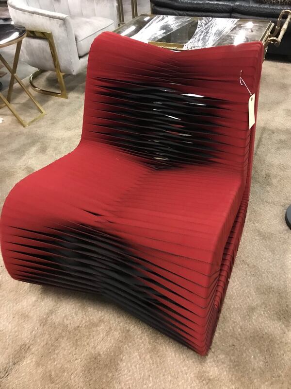 These looks like chairs from "Star" which are made of seatbelts and is far more comfortable than it looks. They are also $795 apiece.