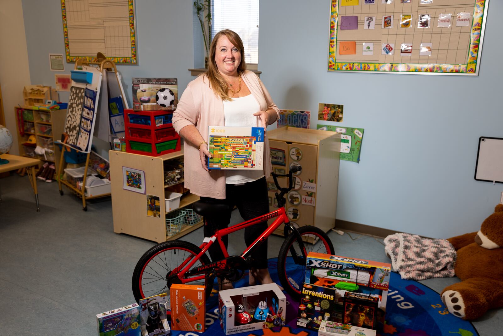 Atlanta Children’s Shelter Executive Director Cameron Turner poses for a portrait with donated Christmas toys at Atlanta Children’s Shelter in Atlanta on Thursday, November 2, 2023. (Arvin Temkar / arvin.temkar@ajc.com)