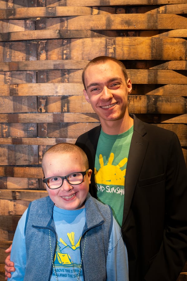 Brothers, Henry 16 (right) and Matthew Hart, 13, pose together at the Sunshine Spectacular dinner in Atlanta on Sunday, March. 9, 2025. (Olivia Bowdoin for the AJC). 