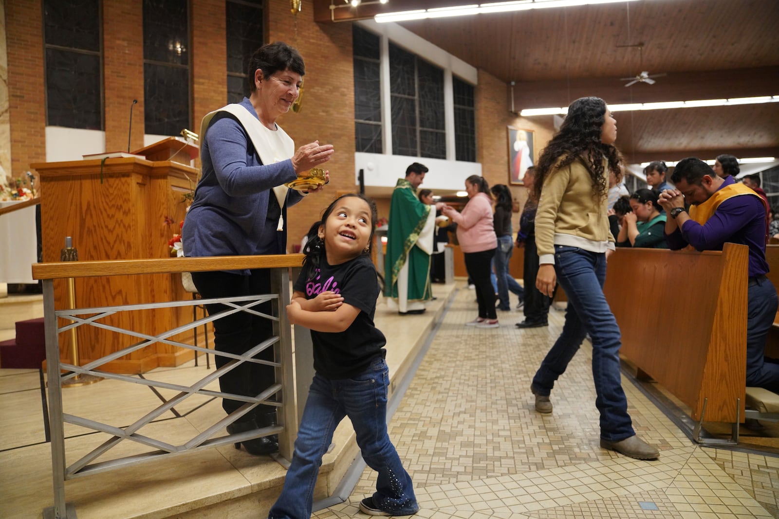 Parishioners take Communion during the Spanish-language Mass at St. Mary’s Catholic Church on Saturday, Oct. 19, 2024, in Worthington, Minn. (AP Photo/Jessie Wardarski)