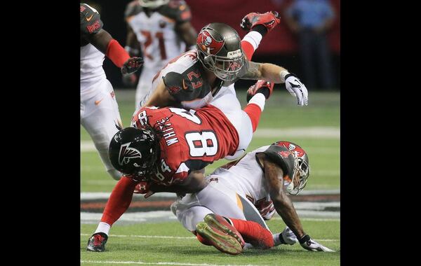 Falcons wide receiver Roddy White is leveled as he makes a first down catch against the Buccaneers during the second half in a football game on Sunday, Nov. 1, 2015, in Atlanta. The Falcons were defeated 23-20 by the Buccaneers in over time. (Photo by Curtis Compton)