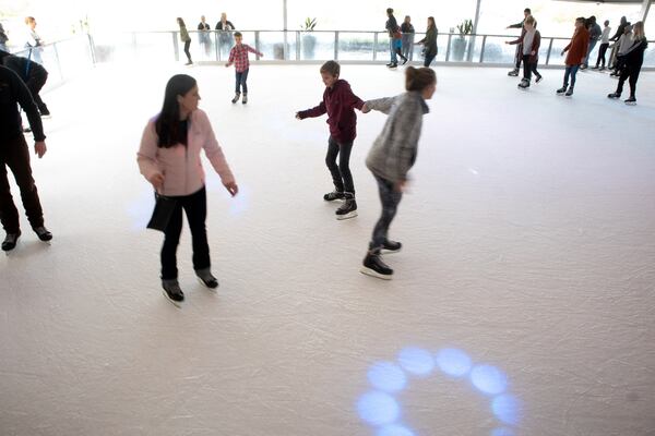 People make their way around the Ice skating rink at Skyline Park on top of  Ponce City Market Sunday, December 23, 2018.  STEVE SCHAEFER / SPECIAL TO THE AJC