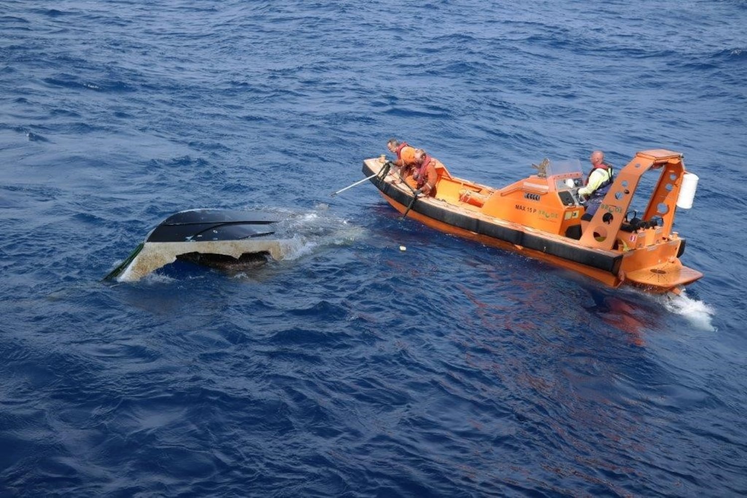 Photos of missing teens' boat being pulled from water