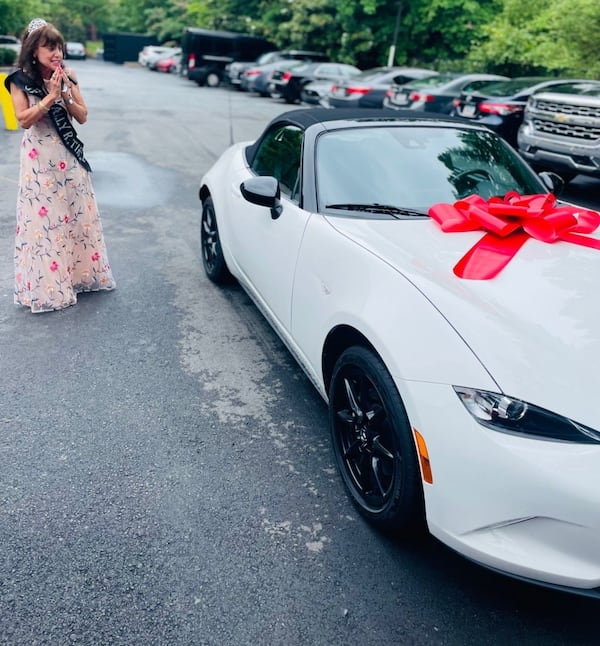 Lynne Gomez with her new car. Courtesy of Ray's Restaurants