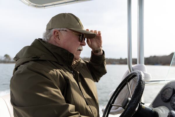 Putnam County Sheriff Howard Sills steers a boat on Lake Oconee in Eatonton on Thursday, as they search for missing Westminster coach Gary Jones.(Arvin Temkar / AJC)