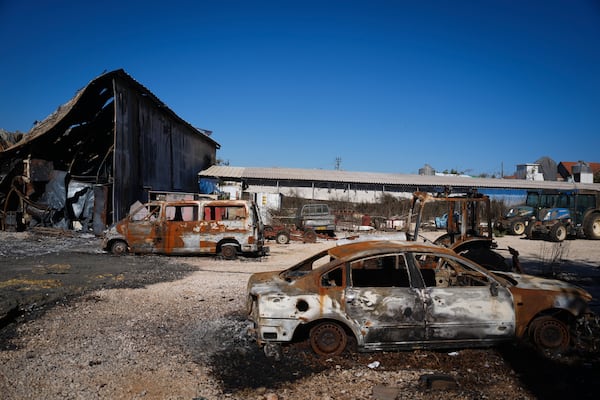 Burned-out cars and buildings from Hezbollah rockets are seen in the agricultural settlement of Avivim, near the Lebanese border in the Upper Galilee, Israel, on Monday Dec. 2, 2024. Despite the ceasefire with Hezbollah, Israelis remain wary of returning to the north. (AP Photo/Ohad Zwigenberg)