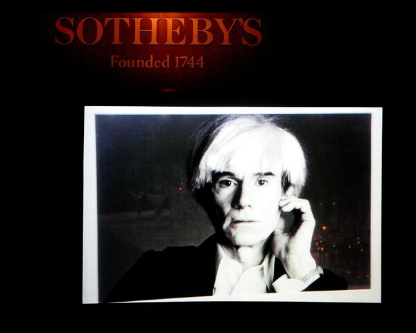 NEW YORK - APRIL 04: A photo of artist Andy Warhol is projected during an auction of photographer Francesco Scavullo's work benefiting Fountain House at Sotheby's April 4, 2006 in New York City. (Photo by Paul Hawthorne/Getty Images) Andy Warhol inspired Andy Cohen for his diary. CREDIT: Getty Images