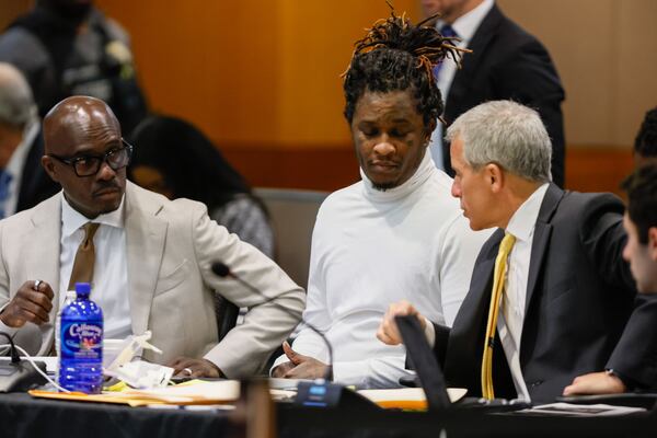 Atlanta rapper Young Thug speaks with defense attorneys Brian Steel and Keith Adams during his ongoing gang and racketeering trial at Fulton County Courthouse on Wednesday, Sept. 4. 2024. His request to modify his probation was partially denied. 
(Miguel Martinez / AJC)