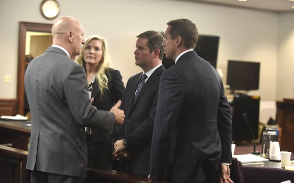 Left-right, Cobb County DA Vic Reynolds congratulates his prosecutors Susan Treadaway, Chuck Boring and Jesse Evans after they won a guilty verdict in the Harris case. John Carrington / For the AJC