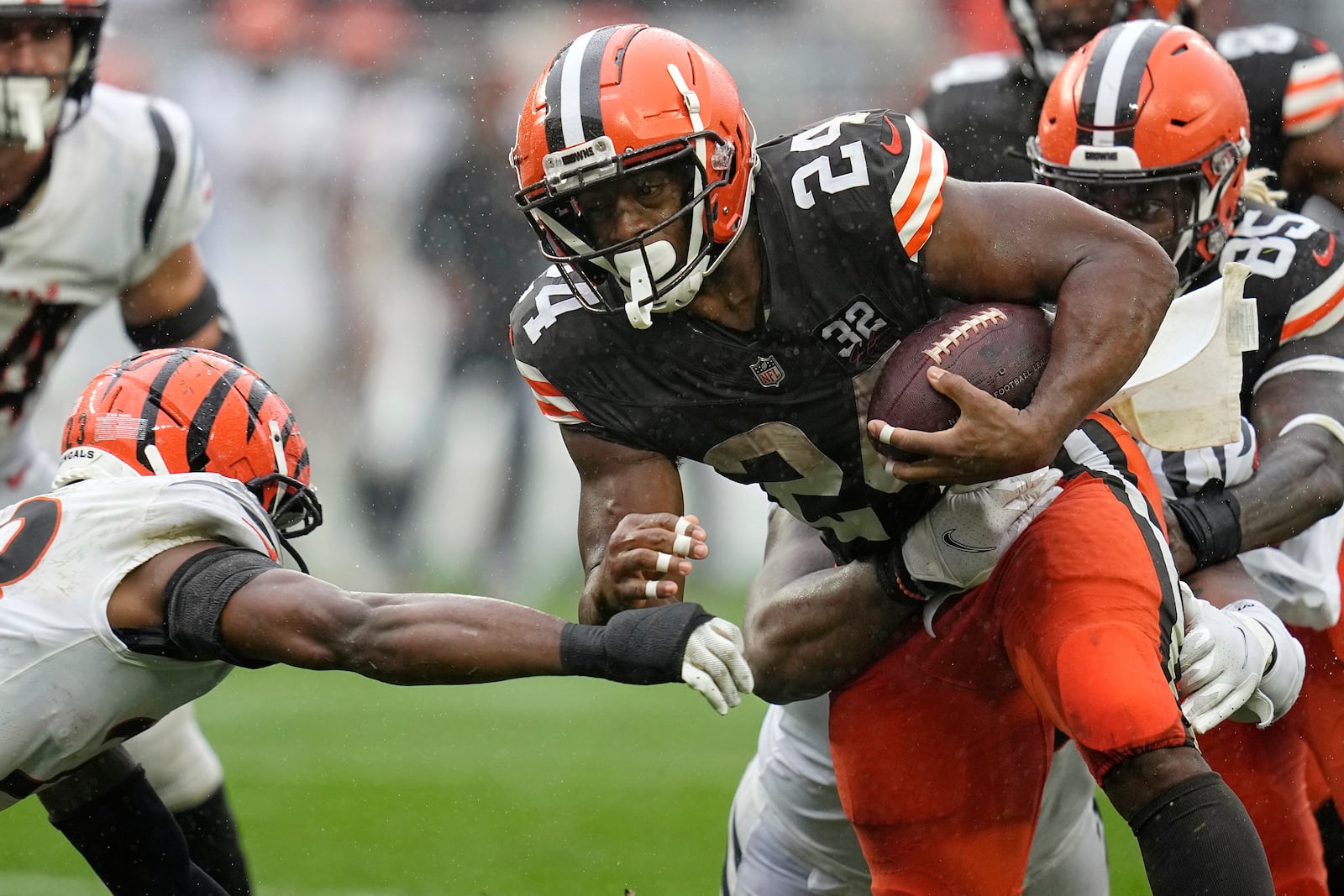 FILE - Cleveland Browns running back Nick Chubb (24) is pressured by Cincinnati Bengals safety Dax Hill, left, during an NFL football game, Sept. 10, 2023, in Cleveland. (AP Photo/Sue Ogrocki, File)