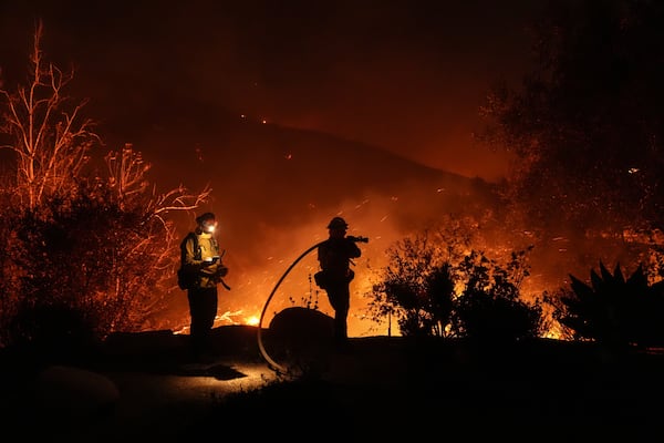 Firefighters battle the Franklin Fire in Malibu, Calif., Tuesday, Dec. 10, 2024. (AP Photo/Jae C. Hong)