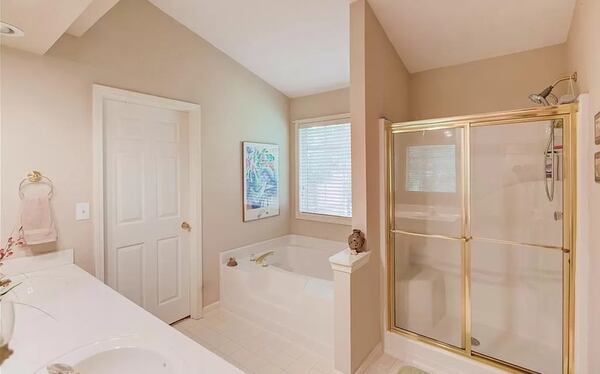 The primary bathroom has a double vanity and garden tub.