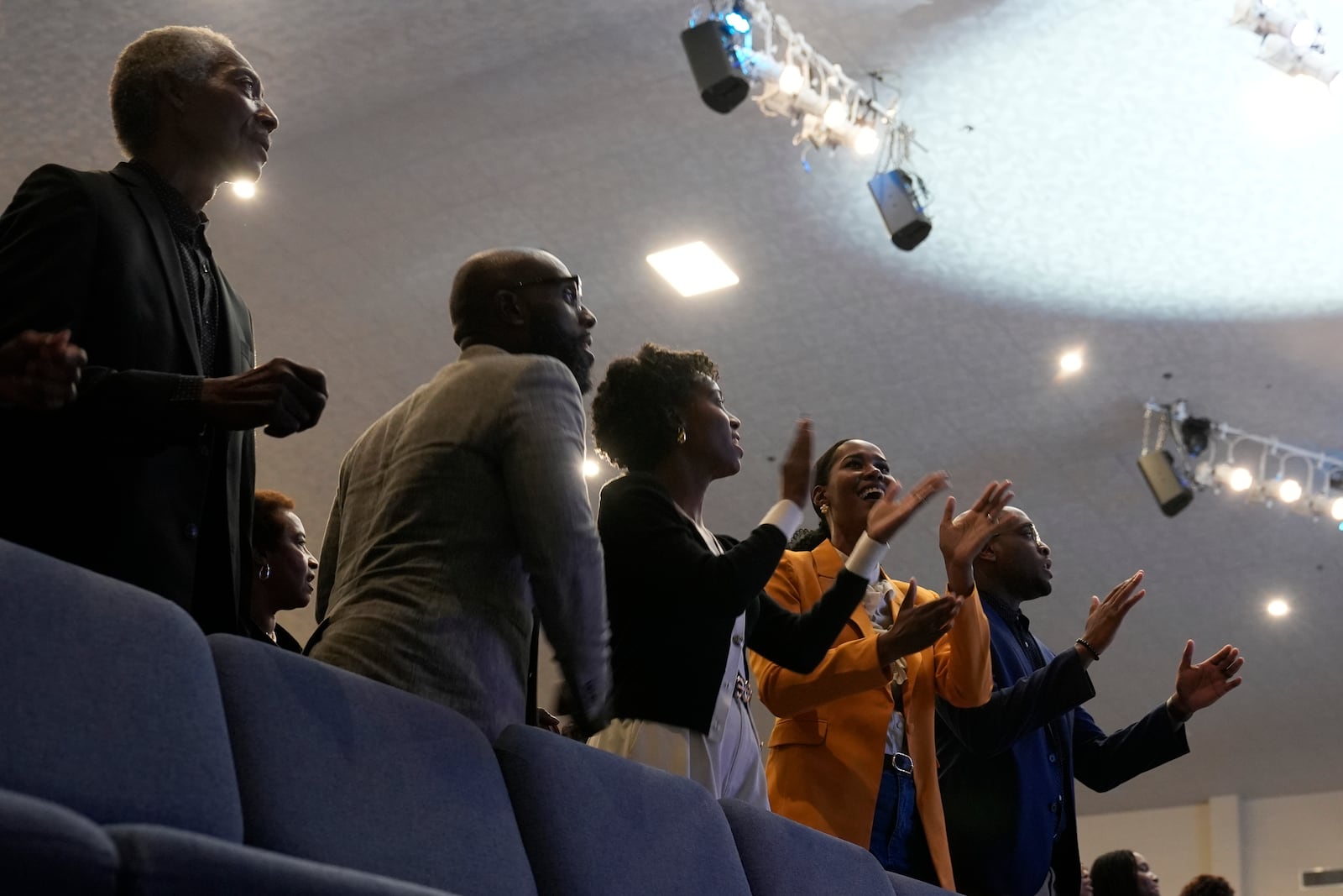 Attendees sing before Democratic presidential nominee Vice President Kamala Harris arrives to speak during a church service at Koinonia Christian Center in Greenville, N.C., Sunday, Oct. 13, 2024. (AP Photo/Susan Walsh)