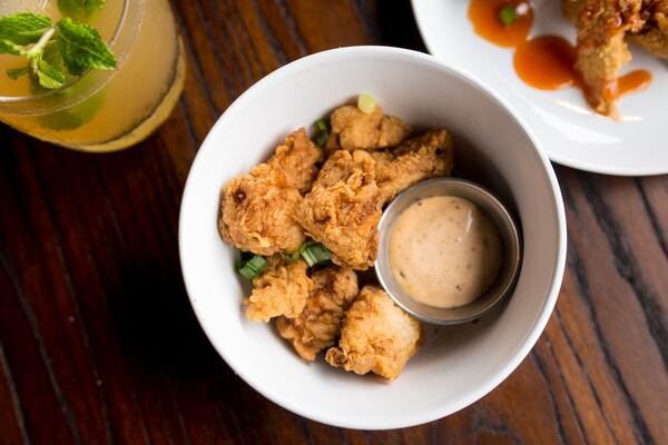 The Shawk Bites — tender shark meat seasoned, lightly battered and fried golden — at Virgil’s Gullah Kitchen and Bar are served with a remoulade for dipping. (Mia Yakel for The Atlanta Journal-Constitution) 