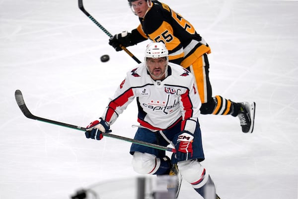 Washington Capitals' Alex Ovechkin (8) watches an airborne puck after a face-off during the first period of an NHL hockey game against the Pittsburgh Penguins in Pittsburgh, Saturday, Feb. 22, 2025. (AP Photo/Gene J. Puskar)