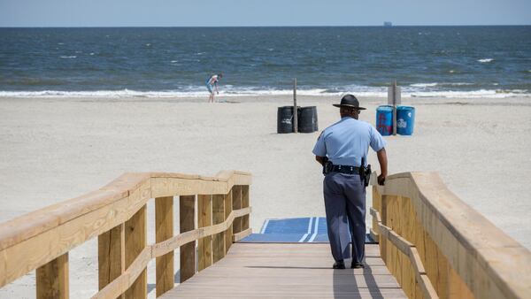 TYBEE ISLAND, GA - APRIL 4, 2020: Georgia State Patrol Capt. Thornell King watches visitors to Tybee Island beach after Gov. Brian Kemp signed an executive order allowing people to exercise outside, with social distancing of at least 6 feet. (AJC Photo/Stephen B. Morton)