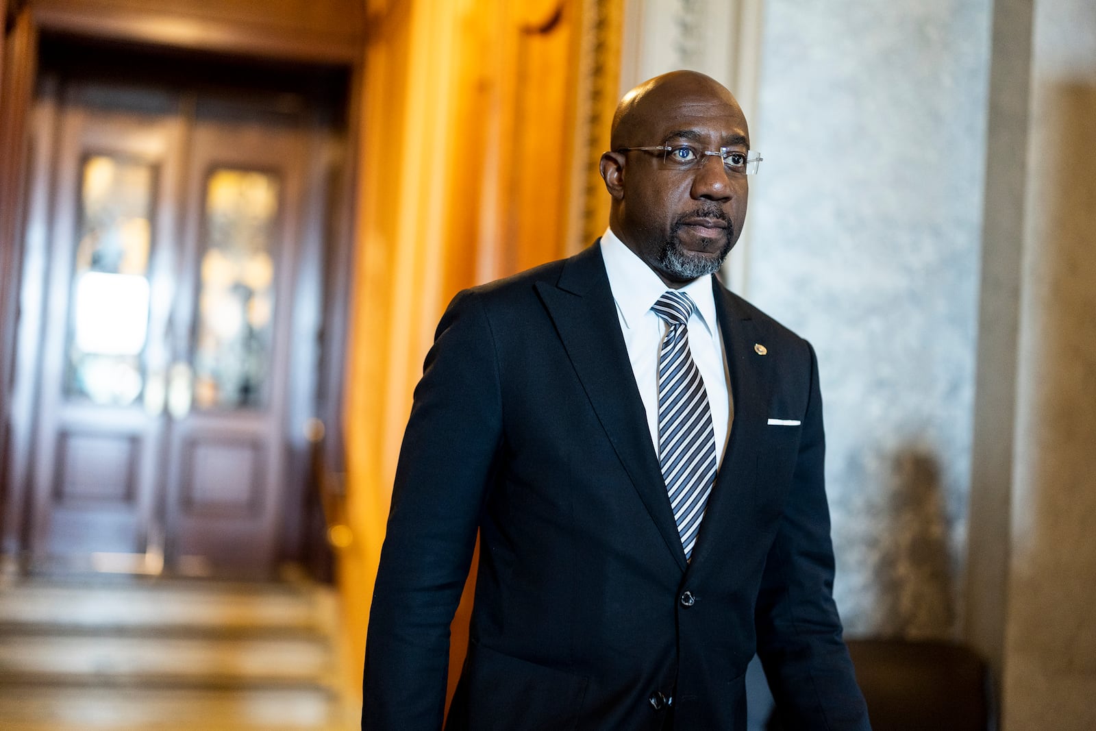 In this photo of May 11, 2022, Sen. Raphael Warnock (D-GA) walks out of the Senate Chambers during a series of votes in the U.S. Capitol Building in Washington, DC. (Anna Moneymaker/Getty Images/TNS)