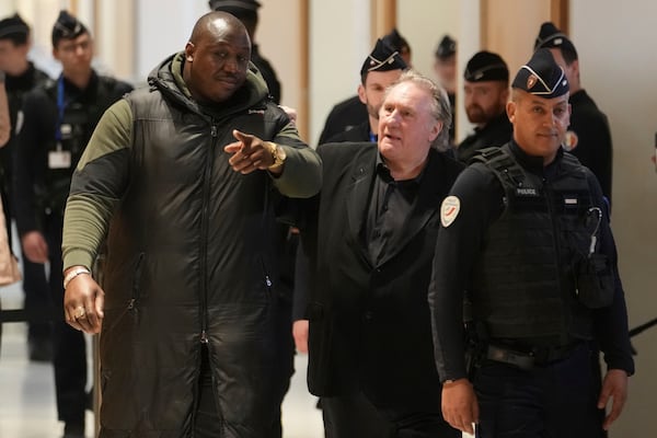 Actor Gerard Depardieu, center, returns to the court after a break as he faces trial for the alleged sexual assaults of two women on a film set in 2021, Monday, March 24, 2025 in Paris. (AP Photo/Thibault Camus)