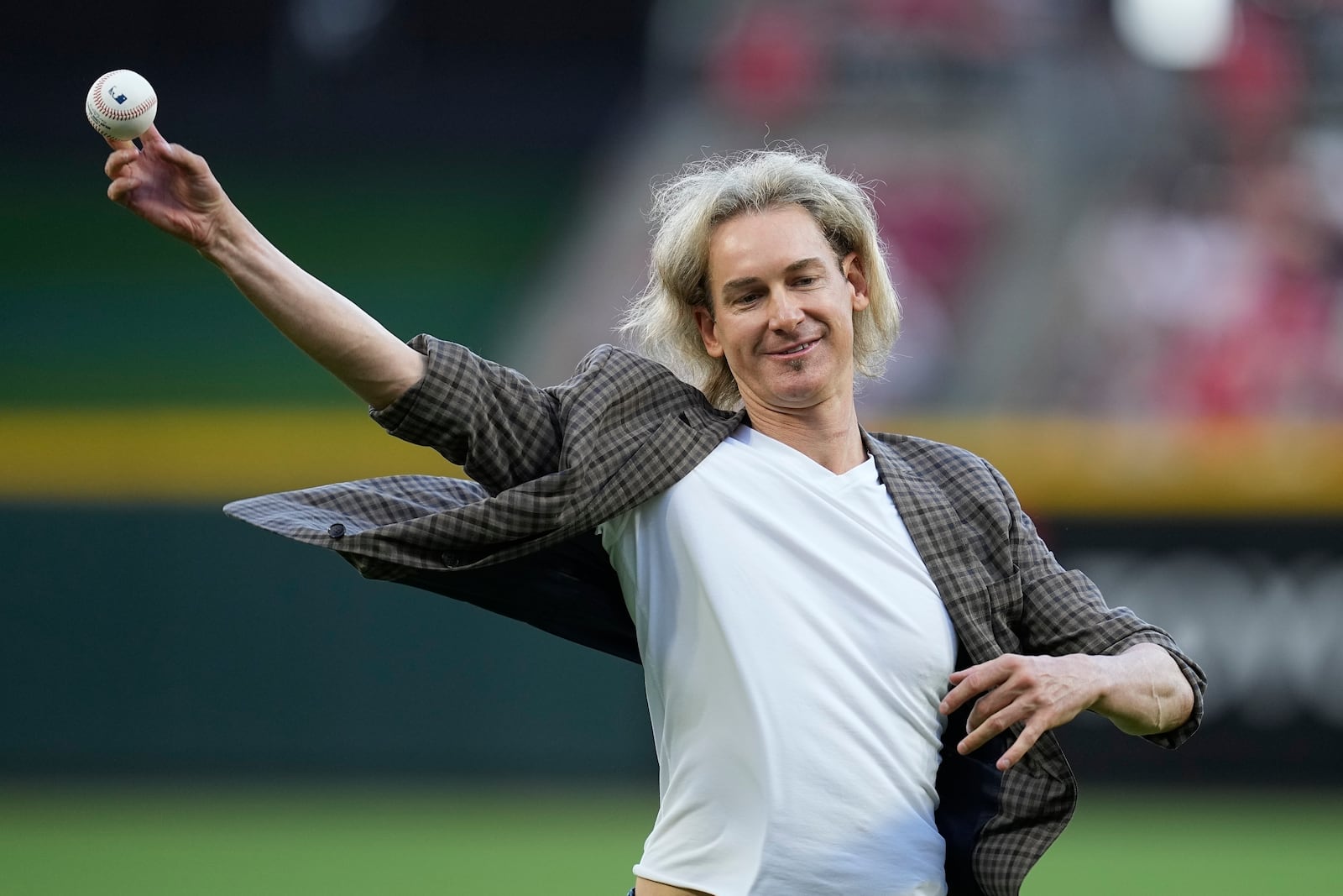 FILE - Former Cincinnati Reds player Bronson Arroyo throws out a ceremonial first pitch before a baseball game between the Reds and the Milwaukee Brewers, July 15, 2023, in Cincinnati. (AP Photo/Darron Cummings, File)