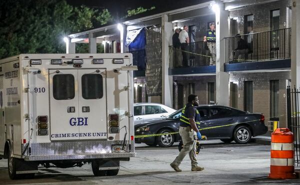 GBI agents collect evidence at an Alcovy Road motel after a shooting Tuesday night that injured a Covington police officer. His suspected shooter was killed by backup officers.

