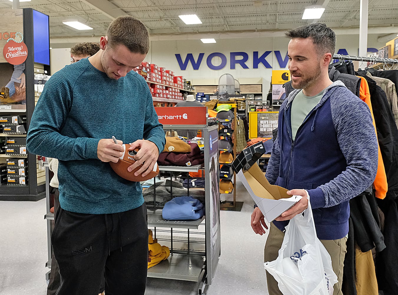 Fans stop Carson Beck in the store for autographs and photos while he was there shopping with the Athens area Boys and Girls club children. UGA Quarterback Carson Beck was on site at an Athen Academy store Sunday December 17, 2023, to give out gift cards to lucky members of area Boys and Girls Clubs. Academy Sports and Outdoors contributed $200 for each child and he kicked in $135 more of his own money to help families out. 

credit: Nell Carroll for the AJC