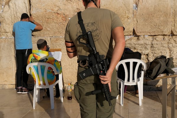 A member of the Israeli security forces prays at the Western Wall in Jerusalem's Old City, Tuesday, Dec. 3, 2024. (AP Photo/Matias Delacroix)