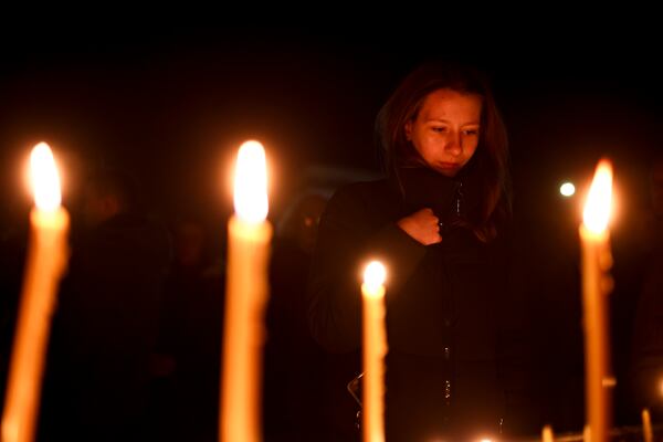 People light candles during a vigil in the town of Kocani, North Macedonia, Tuesday, March 18, 2025 following a massive fire in a nightclub early SUnday. (AP Photo/Armin Durgut)