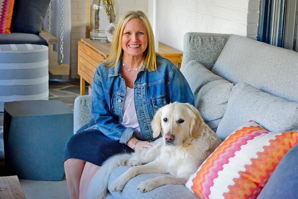 Laura Boone, with her English cream golden retriever, Sunni, purchased the Craftsman home in 2015. Boone is co-owner of Turnerboone commercial interiors.