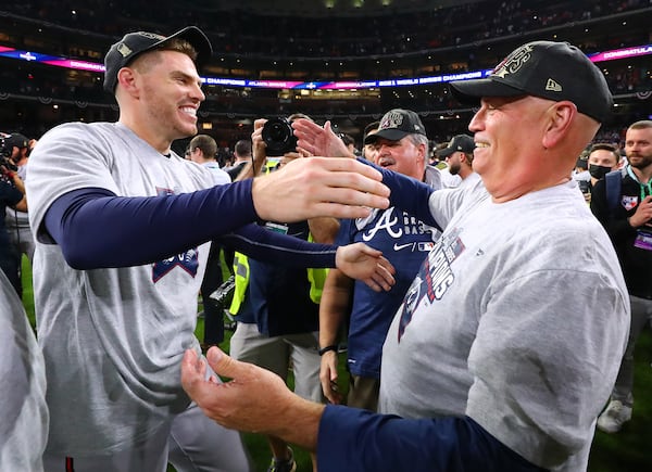 Freddie Freeman and manager Brian Snitker find each other in the midst of the celebration and embrace after beating the Astros in game 6 to win the World Series on Tuesday, Nov. 2, 2021, in Houston.  Freeman is now a free agent.  “Curtis Compton / Curtis.Compton@ajc.com”