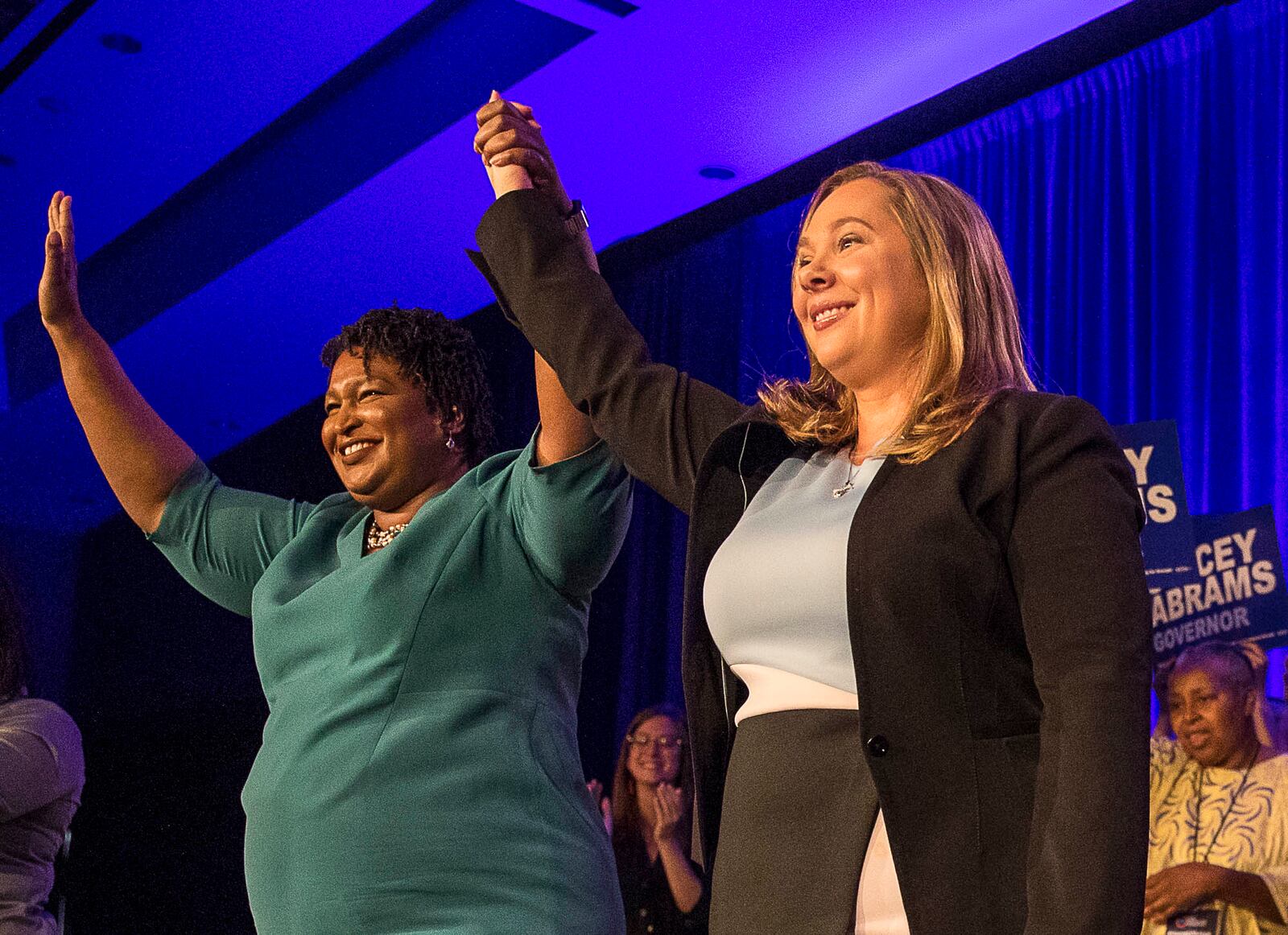 Then-Gubernatorial candidate Stacey Abrams links hands with Lt. Governor candidate Sarah Riggs Amico during the Georgia Democrat convention in 2018.