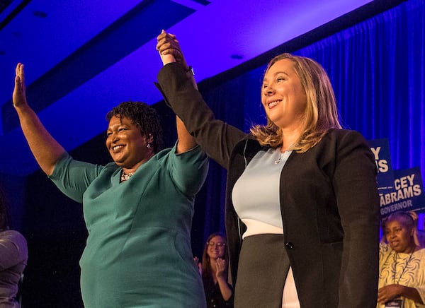 Then-Gubernatorial candidate Stacey Abrams links hands with Lt. Governor candidate Sarah Riggs Amico during the Georgia Democrat convention in 2018.