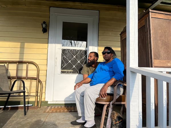 Clara Thomas and her family, like essentially everyone who lives in the South Georgia city of Plains, saw former president Jimmy Carter at times throughout their lives. Thomas is pictured on her front porch with her son Patrick Thomas on Feb. 22, 2023. MATT KEMPNER / AJC