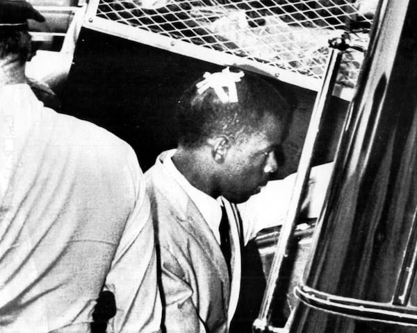 In 1961, John Lewis became one of the original 13 Freedom Riders — a group of black and white activists who rode buses together across the South to challenge segregation in those states' bus terminals. The riders were often met with violence and arrests, including a vicious attack in Rock Hill, S.C. that left Lewis severely beaten. (A Klansman who attacked Lewis in Rock Hill would apologize to him in 2010.) Here, he is arrested in Jackson, Miss., with a bandage on his head. (UPI pb/Files)