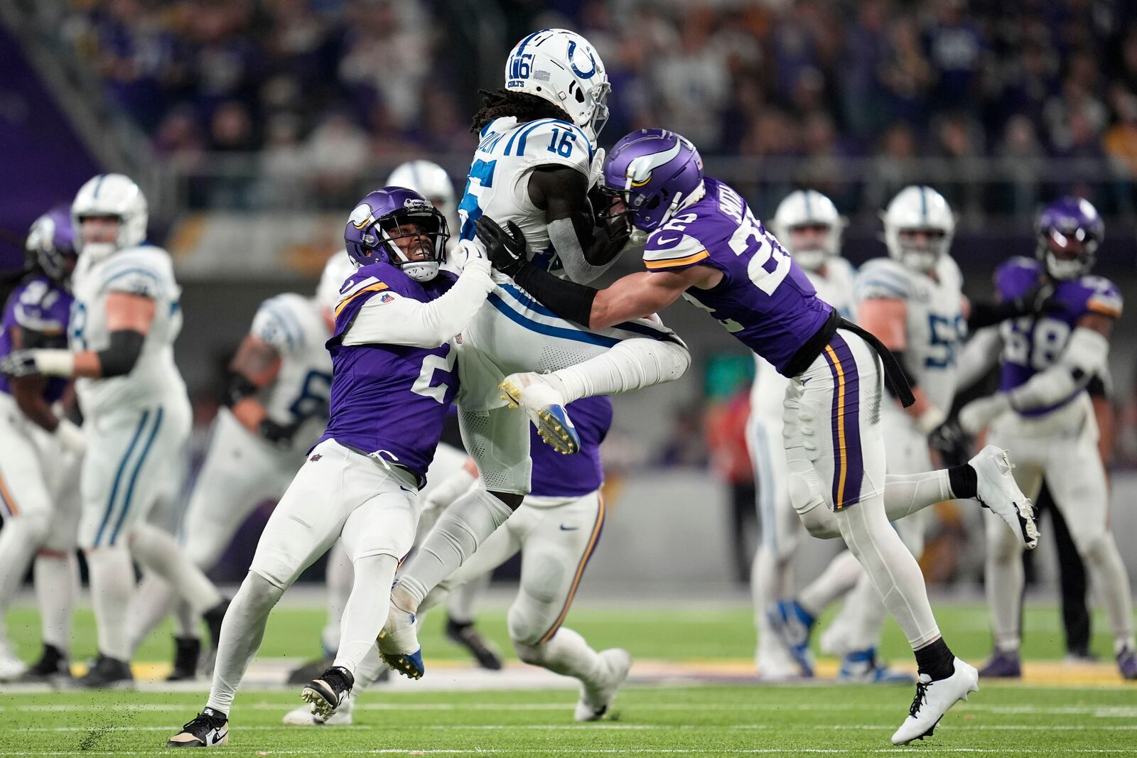 Minnesota Vikings cornerback Stephon Gilmore (2) and safety Harrison Smith (22) break up a pass intended for Indianapolis Colts wide receiver Ashton Dulin (16) during the second half of an NFL football game, Sunday, Nov. 3, 2024, in Minneapolis. (AP Photo/Abbie Parr)