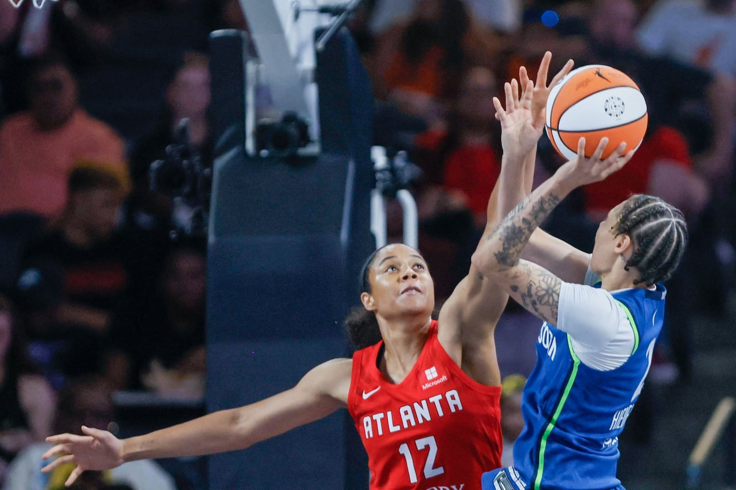 Atlanta Dream forward Nia Coffey (12) tries to block a shot from Minnesota Lynx guard Natisha Hiedeman during the second half at Gateway Center Arena, Sunday, May 26, 2024, in Atlanta. (Miguel Martinez / AJC)