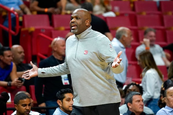 Atlanta Hawks coach Nate McMillan watches during the first half of the team's NBA basketball game against the Miami Heat, Friday, April 8, 2022, in Miami. (AP Photo/Lynne Sladky)