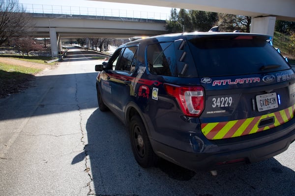 An Atlanta Police car near the scene of a reported body found under the I-20 bridge Thursday. (STEVE SCHAEFER FOR THE ATLANTA JOURNAL-CONSTITUTION)