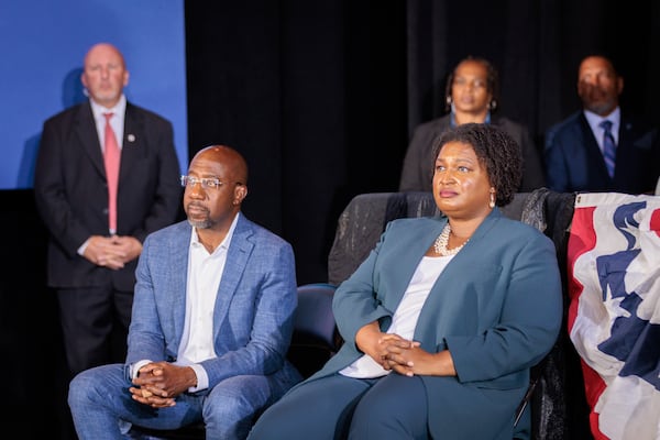 Democratic U.S. Sen Raphael Warnock and gubernatorial candidate Stacey Abrams listen to former President Barack Obama speak Oct. 28 at a rally for the party's candidates. Warnock and Abrams took different approaches to President Joe Biden's administration during their campaigns, with Warnock keeping the president at arm's length while Abrams maintained strong support for him. Now that she has lost the race for governor, a position in Biden's Cabinet could be a next step. (Arvin Temkar / arvin.temkar@ajc.com)