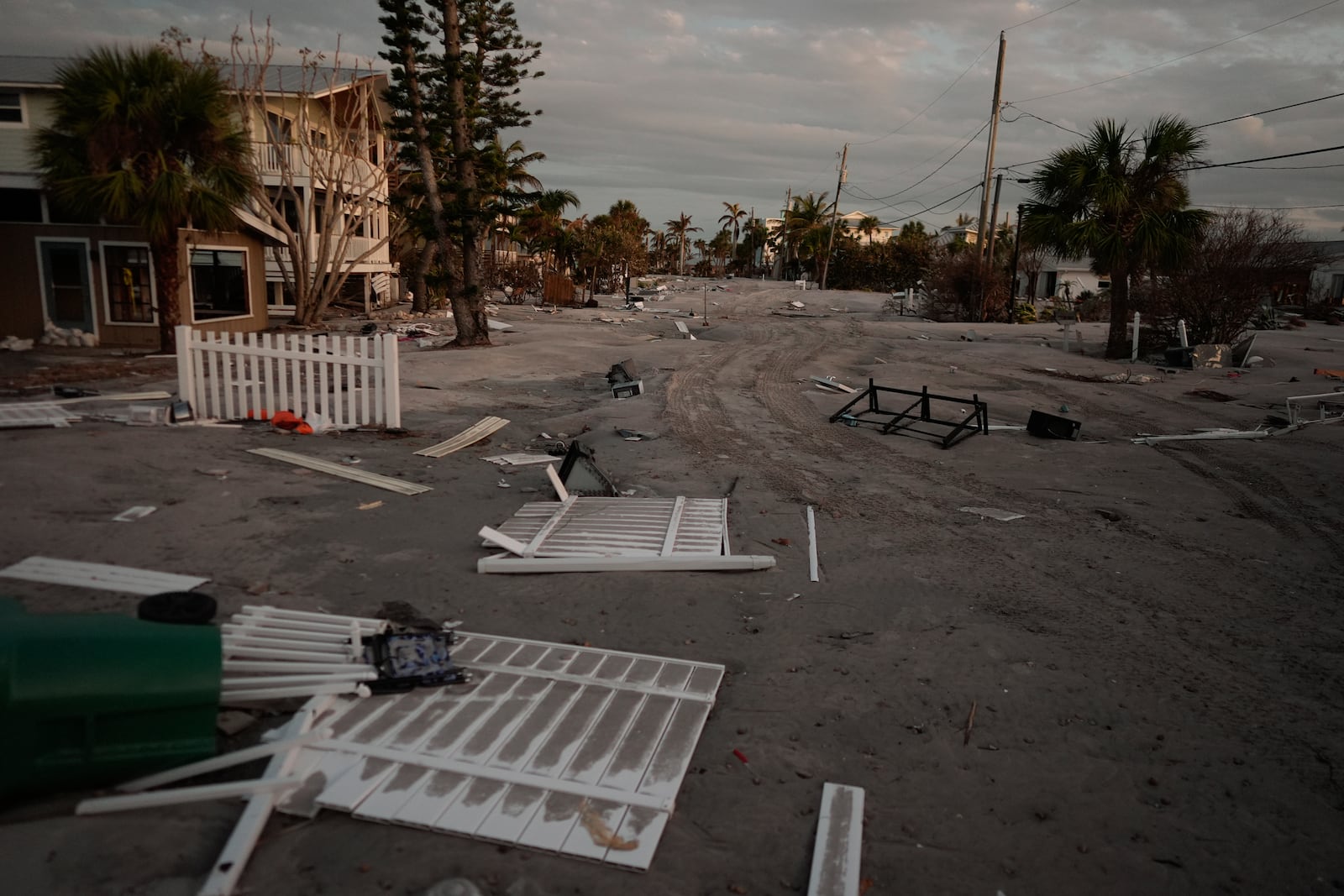 A section of the island's main road not yet reached by county work crews remains covered in feet of sand following the passage of Hurricane Milton, on Manasota Key, Fla., Saturday, Oct. 12, 2024. (AP Photo/Rebecca Blackwell)