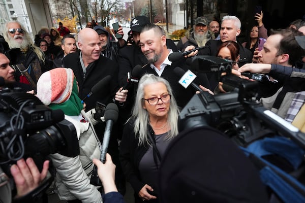 Pat King, top center, a prominent figure in Canada’s trucker protests against COVID-19 restrictions in 2022, is surrounded by supporters and media as he leaves court in Ottawa, Ontario, Friday, Nov. 22, 2024. (Sean Kilpatrick/The Canadian Press via AP)