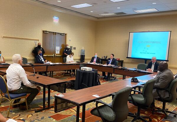 Ryan Gravel, left, of the Stone Mountain Action Coalition, addresses the Stone Mountain Memorial Association board during a special called meeting on Monday, Sept. 14, 2020. TYLER ESTEP / TYLER.ESTEP@AJC.COM