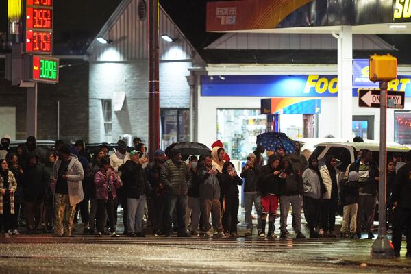 Bystanders watch as first responders work the scene after a small plane crashed in Philadelphia, Friday, Jan. 31, 2025. (AP Photo/Matt Rourke)