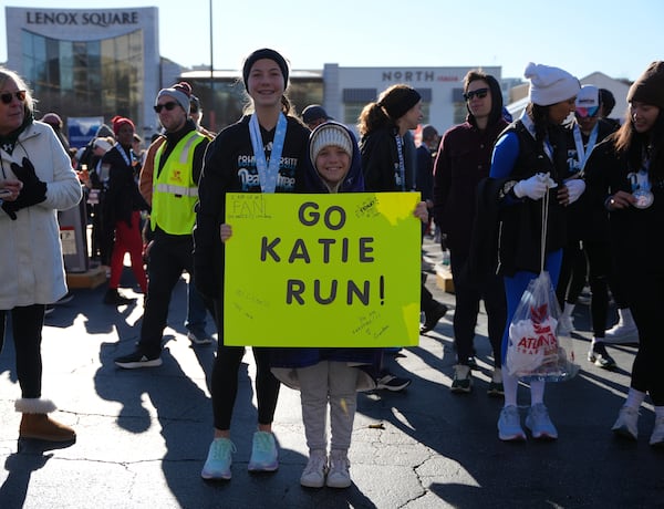 Molly Hill, 8, stood at the finish line with this yellow poster board to champion her sister, 14-year-old Katie Hill, who took part in the race. "The last two miles were hard. They were really hard. I kind of died,” Katie says. But she adds that her sister’s sign helped. “It gave me a little kick at the end.”