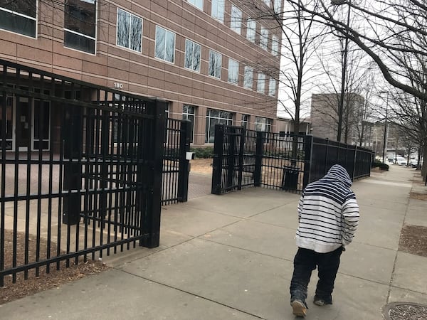 A man walks past the entrance gate to the U.S. Immigration Court in downtown Atlanta. (Jeremy Redmon/AJC 2019)