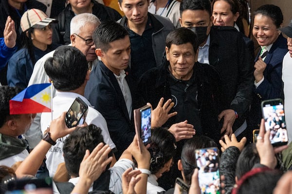 Former President of the Philippines Rodrigo Duterte arrives inside the Southorn Stadium during a thanksgiving gathering organized by Hong Kong-based Filipino workers for the former populist president in Hong Kong on Sunday, March 9, 2025. (AP Photo/Vernon Yuen)